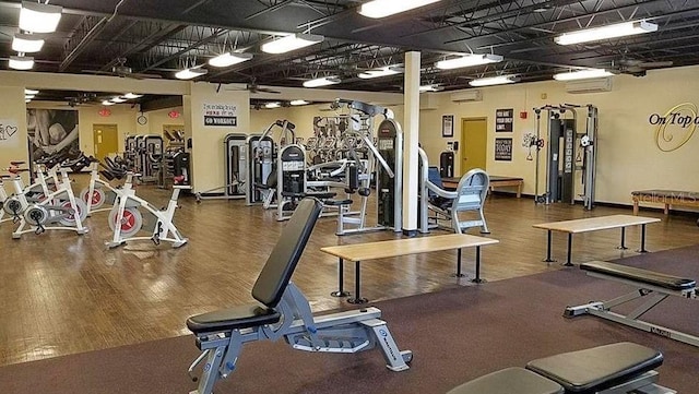 gym featuring baseboards and wood finished floors