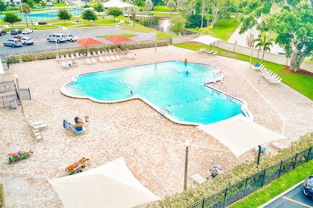 community pool featuring a patio area and fence