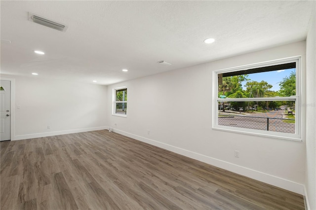 8319 N 14th St, Tampa, FL 33604 - spare room featuring baseboards, wood finished floors, and recessed lighting
