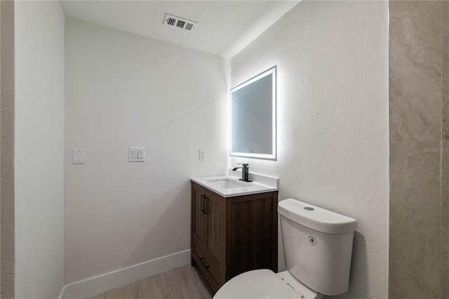 8319 N 14th St, Tampa, FL 33604 - half bath featuring vanity, toilet, and wood finished floors