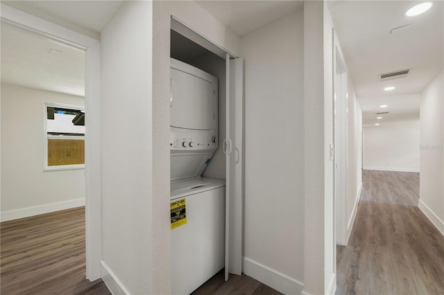8319 N 14th St, Tampa, FL 33604 - washroom featuring stacked washing machine and dryer, wood finished floors, and baseboards