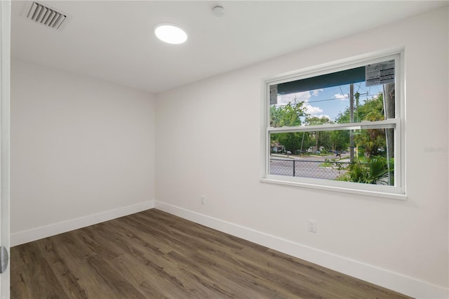 8319 N 14th St, Tampa, FL 33604 - unfurnished room with baseboards, wood finished floors, and a smoke detector