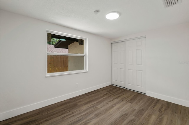 8319 N 14th St, Tampa, FL 33604 - unfurnished bedroom featuring baseboards, wood finished floors, and a closet