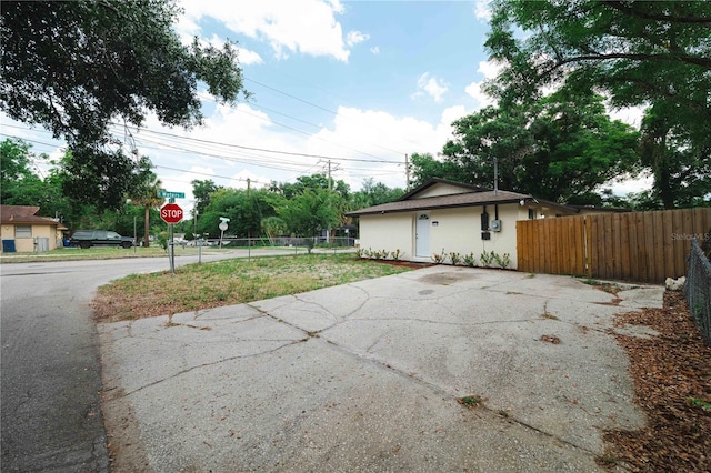 8319 N 14th St, Tampa, FL 33604 - view of property exterior featuring asphalt driveway and stucco siding