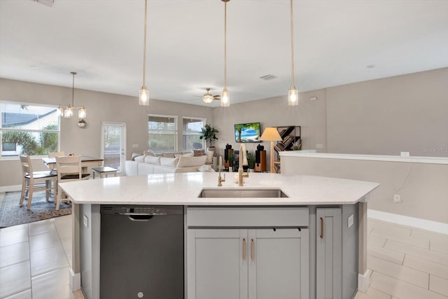 kitchen featuring a wealth of natural light, black dishwasher, open floor plan, and a sink