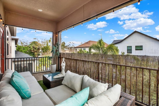 exterior space featuring outdoor lounge area and a balcony