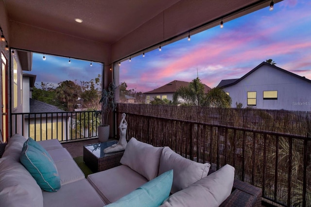 exterior space featuring a balcony and an outdoor hangout area