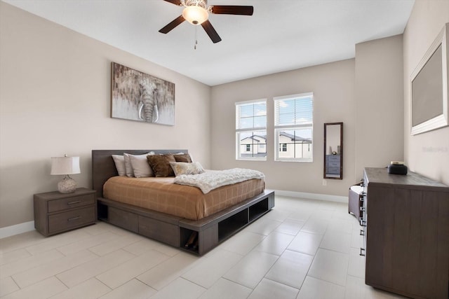 bedroom with a ceiling fan and baseboards