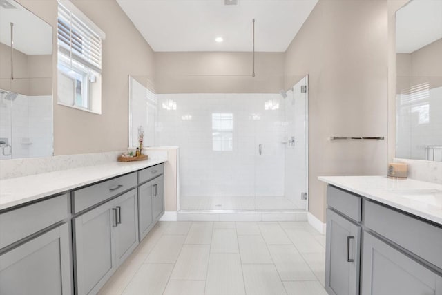 full bathroom with a shower stall and vanity