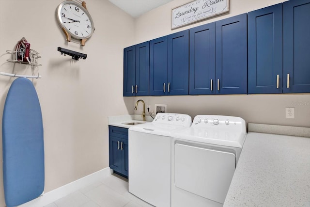 clothes washing area with cabinet space, baseboards, a sink, and independent washer and dryer