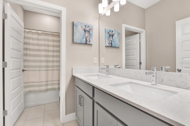 full bath featuring double vanity, tile patterned flooring, a sink, and shower / bath combo