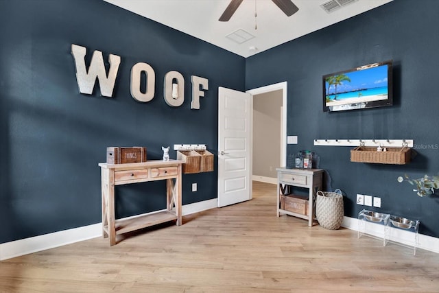 interior space with wood finished floors, visible vents, and baseboards