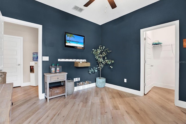 interior space with visible vents, baseboards, and wood finished floors