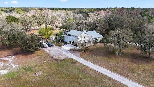 birds eye view of property featuring a wooded view