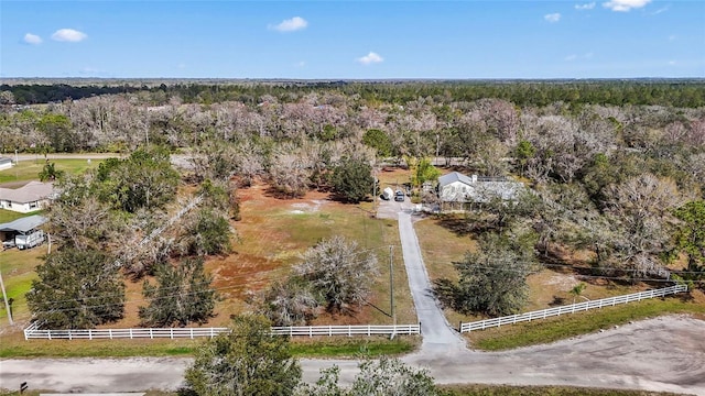 birds eye view of property with a view of trees