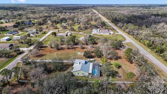 birds eye view of property featuring a wooded view