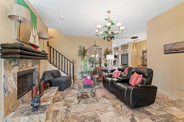 living area featuring stairway, a fireplace with raised hearth, baseboards, and a chandelier