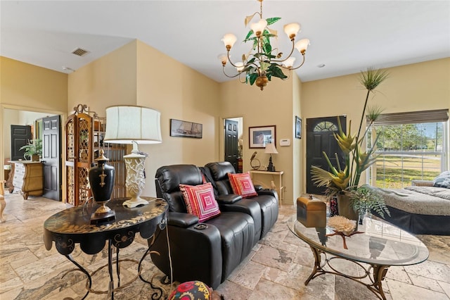 living area featuring a notable chandelier, visible vents, and stone tile flooring