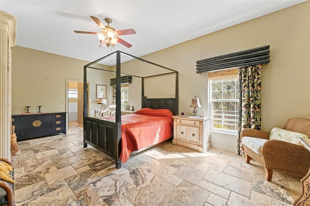 bedroom featuring stone tile floors and a ceiling fan