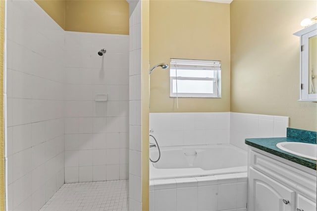 bathroom featuring vanity, a garden tub, and tiled shower