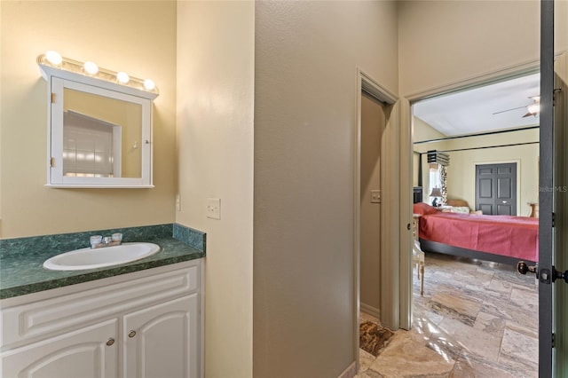 bathroom featuring vanity, ensuite bath, and stone finish flooring