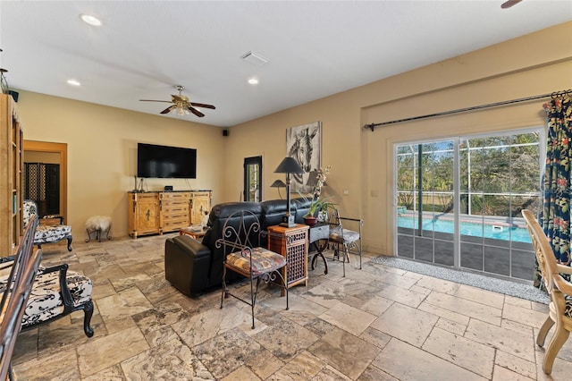 living area with stone tile floors, recessed lighting, a ceiling fan, and visible vents