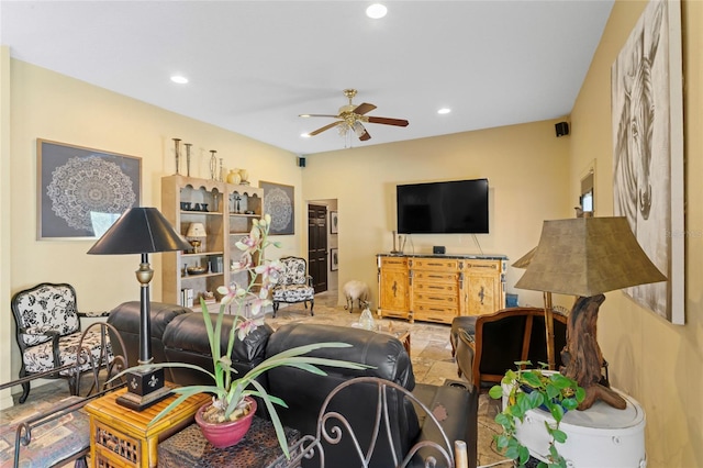 living room featuring stone tile flooring, ceiling fan, and recessed lighting