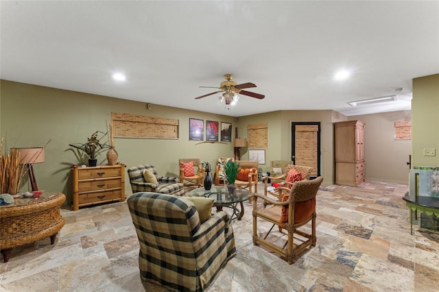 living area featuring stone tile floors, recessed lighting, baseboards, and a ceiling fan