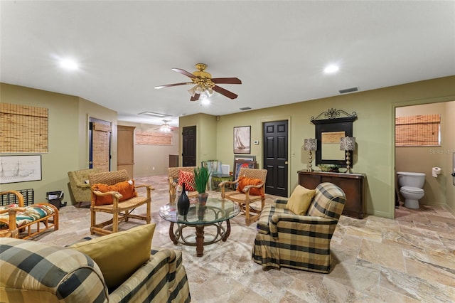 living area featuring stone finish floor, recessed lighting, visible vents, and ceiling fan