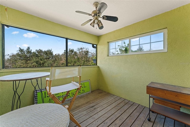 sunroom featuring ceiling fan