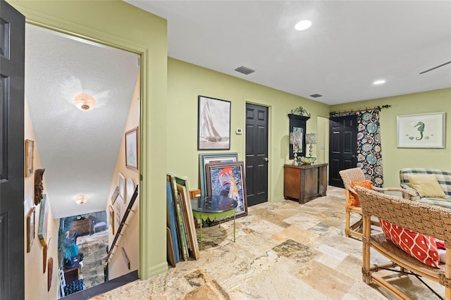 interior space with recessed lighting, baseboards, visible vents, and stone finish flooring