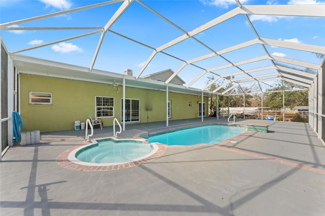 view of swimming pool with ceiling fan, a patio, a pool with connected hot tub, and a lanai