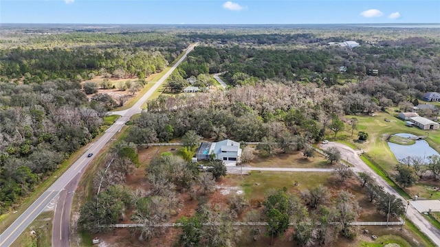 aerial view featuring a wooded view