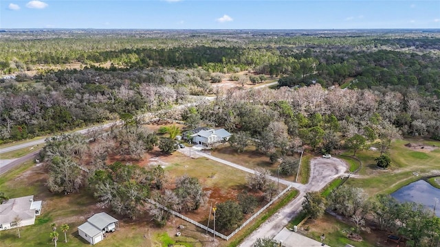 drone / aerial view featuring a wooded view