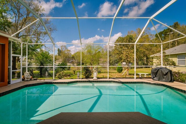 pool with a patio, a lanai, and area for grilling