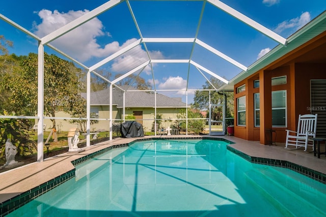 pool featuring grilling area, a patio, and a lanai