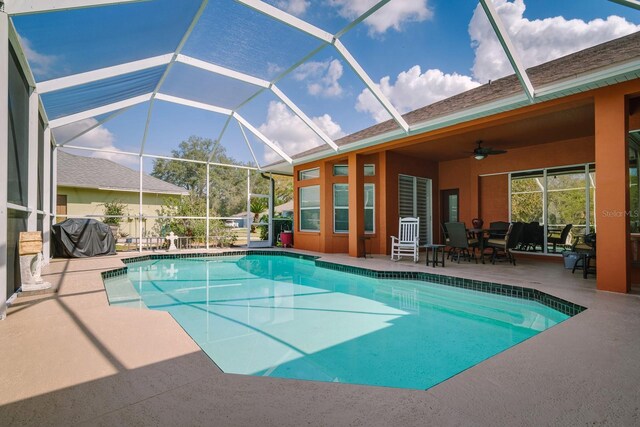 pool with a grill, outdoor dining area, a ceiling fan, a patio area, and a lanai