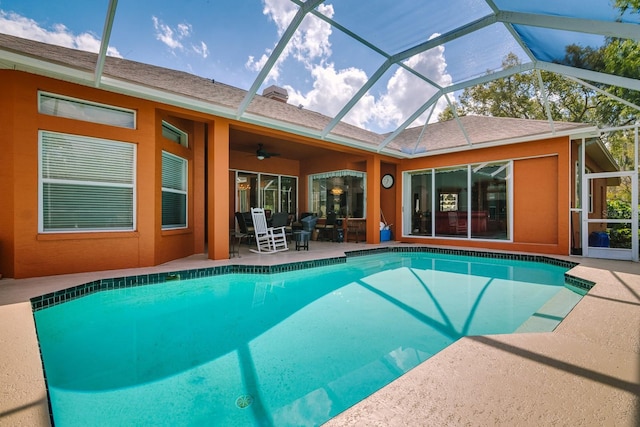 pool with ceiling fan, a patio area, and a lanai