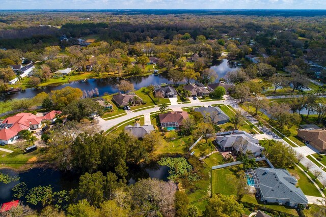 aerial view with a water view, a residential view, and a forest view