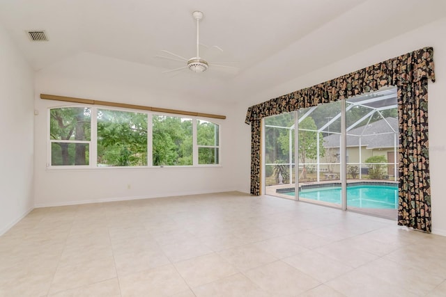 unfurnished room with ceiling fan, visible vents, vaulted ceiling, a sunroom, and baseboards