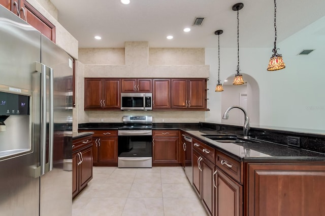 kitchen with a sink, appliances with stainless steel finishes, a peninsula, and visible vents
