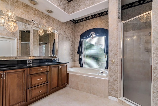 full bathroom with double vanity, a garden tub, a shower stall, a sink, and tile patterned floors