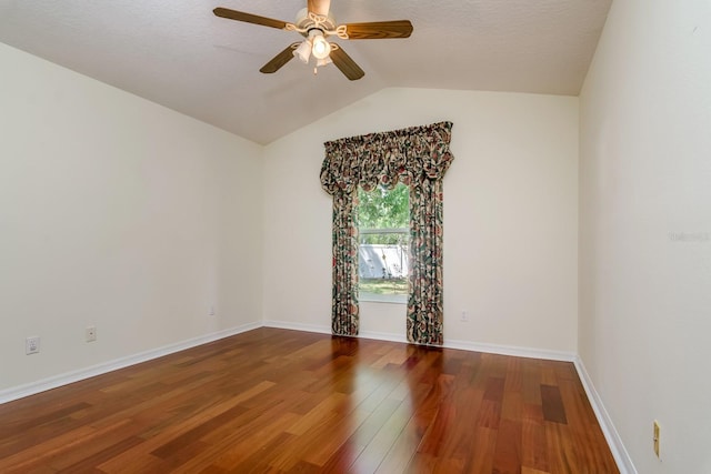 unfurnished room featuring wood finished floors, baseboards, ceiling fan, and lofted ceiling