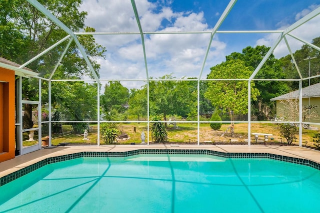 outdoor pool with glass enclosure and a patio