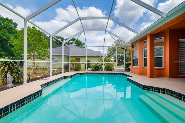 outdoor pool with a patio and a lanai