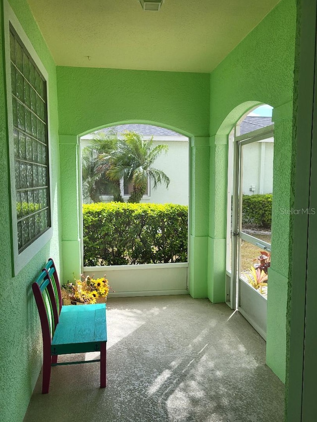 unfurnished sunroom featuring lofted ceiling