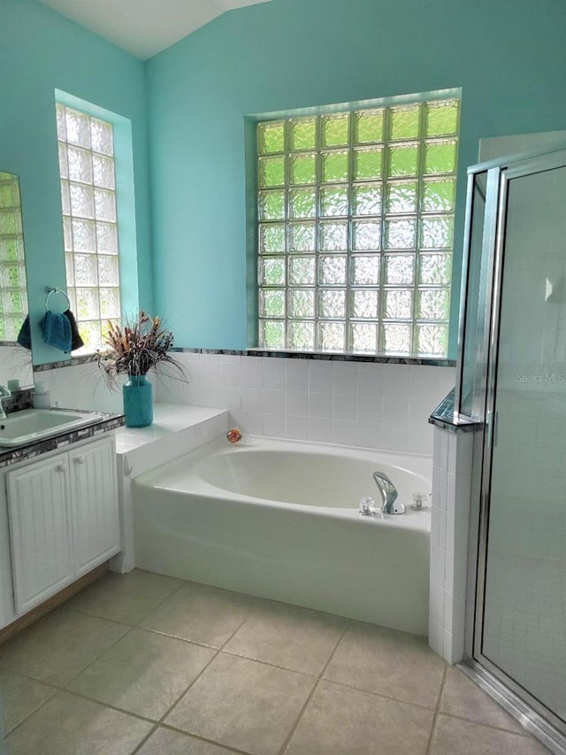 bathroom with a garden tub, a shower stall, vanity, and tile patterned floors