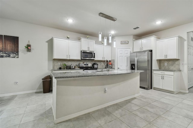 kitchen featuring a sink, white cabinetry, visible vents, appliances with stainless steel finishes, and light stone countertops