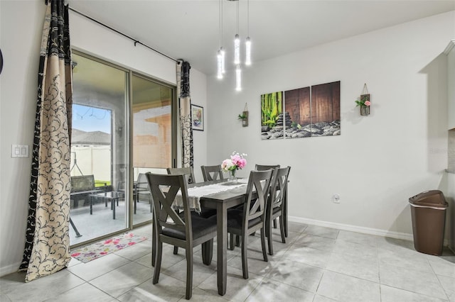 dining area featuring baseboards and light tile patterned flooring