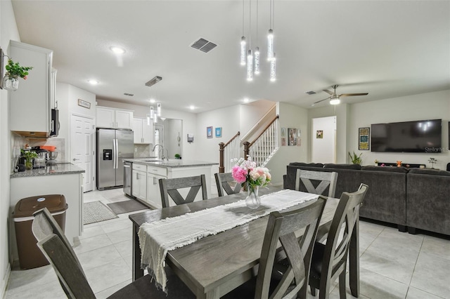 dining room with ceiling fan, light tile patterned flooring, recessed lighting, visible vents, and stairway